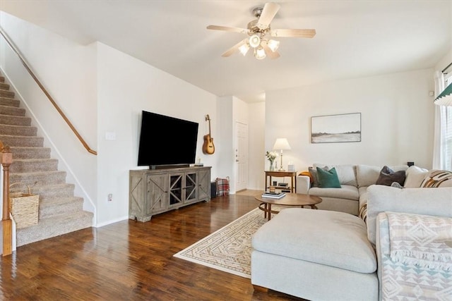 living area with ceiling fan, stairway, and wood finished floors