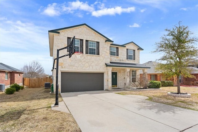 traditional-style home featuring a garage, stone siding, fence, and concrete driveway