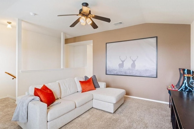 carpeted living area featuring lofted ceiling, baseboards, visible vents, and a ceiling fan