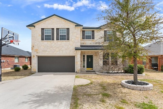 view of front of property featuring a garage, concrete driveway, central AC unit, and stone siding