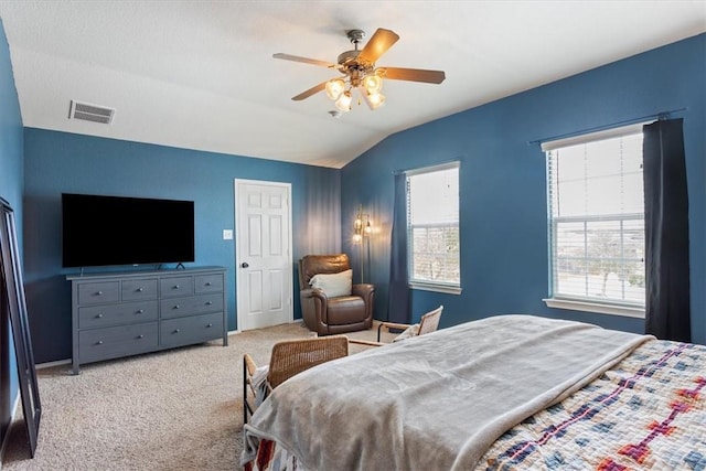 bedroom featuring carpet flooring, vaulted ceiling, visible vents, and ceiling fan