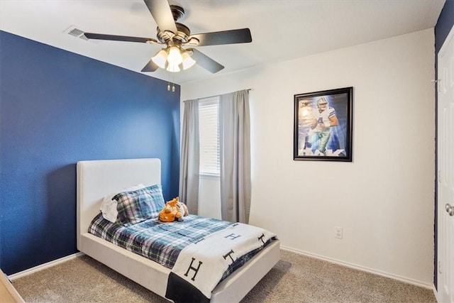 carpeted bedroom with ceiling fan and baseboards