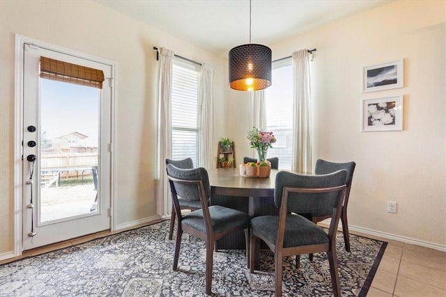 dining room with baseboards and light tile patterned floors