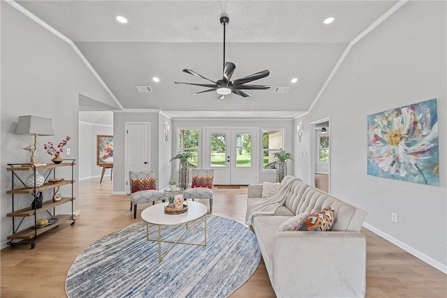 living room with ceiling fan, light hardwood / wood-style floors, lofted ceiling, and crown molding