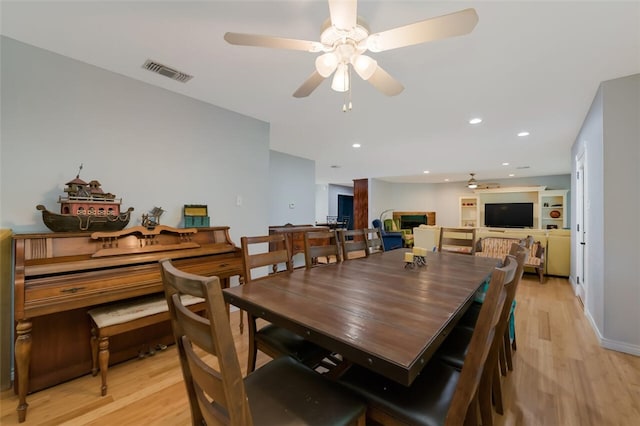 dining room featuring light hardwood / wood-style flooring and ceiling fan