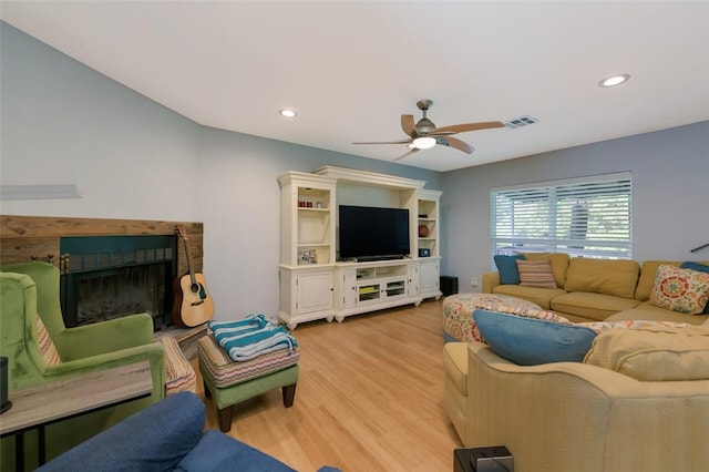 living room with ceiling fan and light wood-type flooring