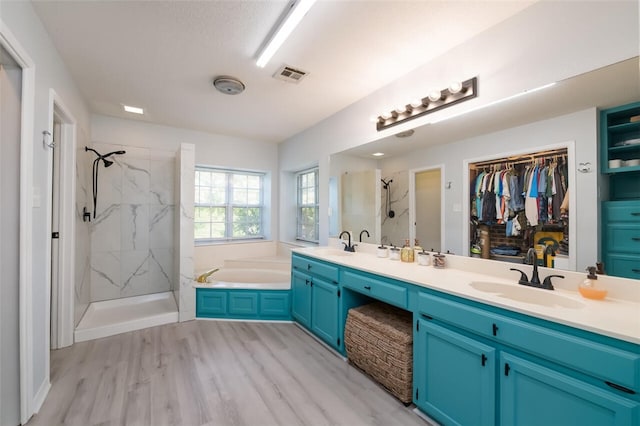 bathroom featuring independent shower and bath, vanity, and hardwood / wood-style floors