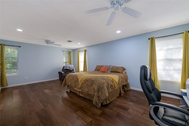 bedroom with dark hardwood / wood-style flooring and ceiling fan