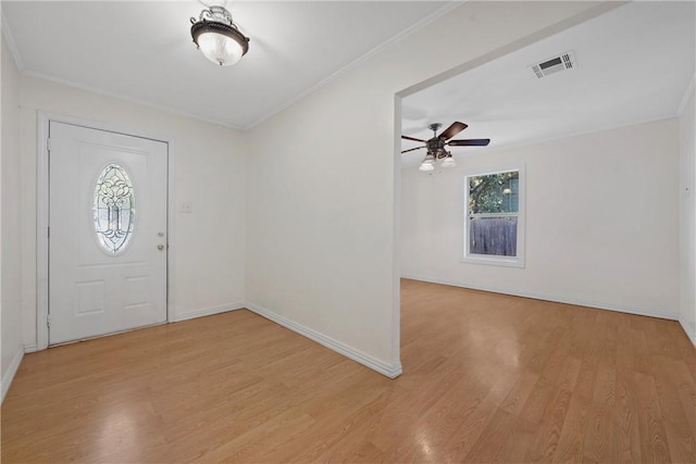 foyer entrance featuring light wood-type flooring, ceiling fan, and ornamental molding