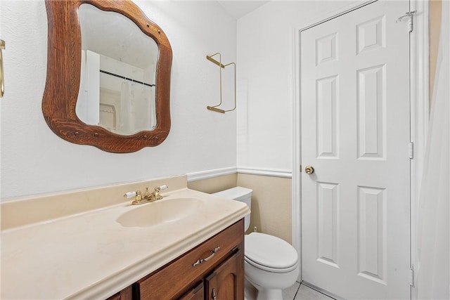 bathroom with tile patterned floors, vanity, and toilet