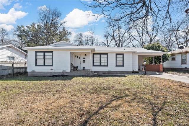 view of front of property with a carport, concrete driveway, fence, and a front lawn