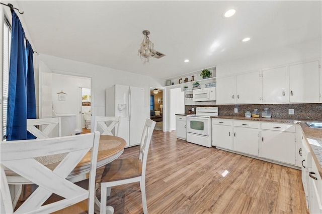 kitchen with white appliances, white cabinets, light wood-style flooring, backsplash, and recessed lighting