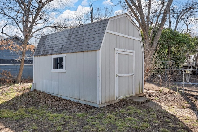 view of shed featuring fence