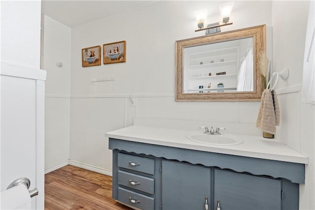 bathroom with wood finished floors and vanity