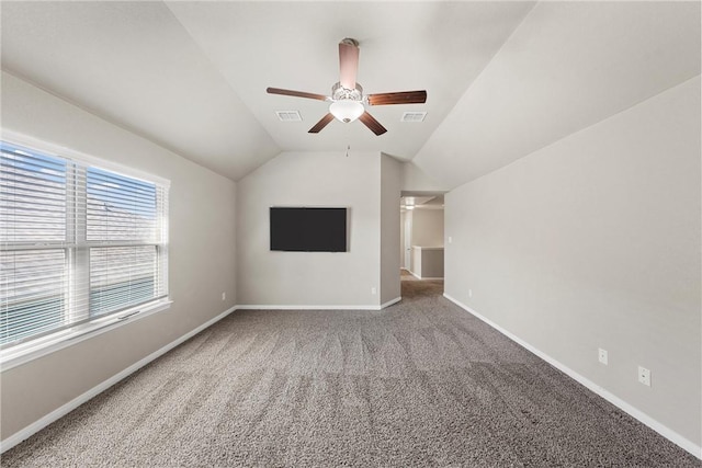 unfurnished living room with visible vents, baseboards, ceiling fan, and vaulted ceiling