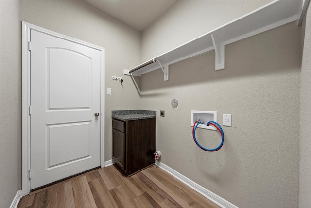 washroom with wood finished floors, baseboards, hookup for an electric dryer, laundry area, and washer hookup