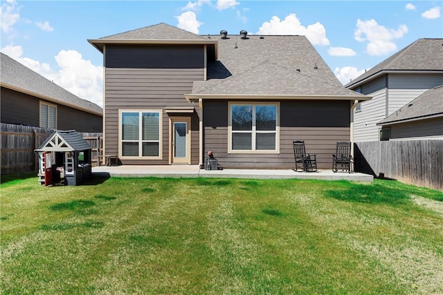 back of house featuring a patio, a lawn, and a fenced backyard