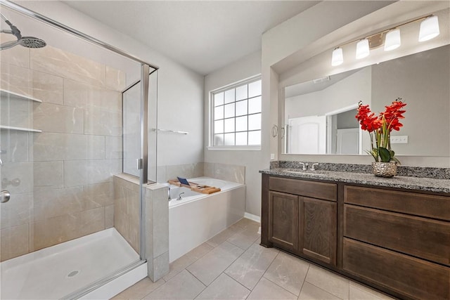 full bathroom featuring vanity, a shower stall, a bath, and tile patterned flooring