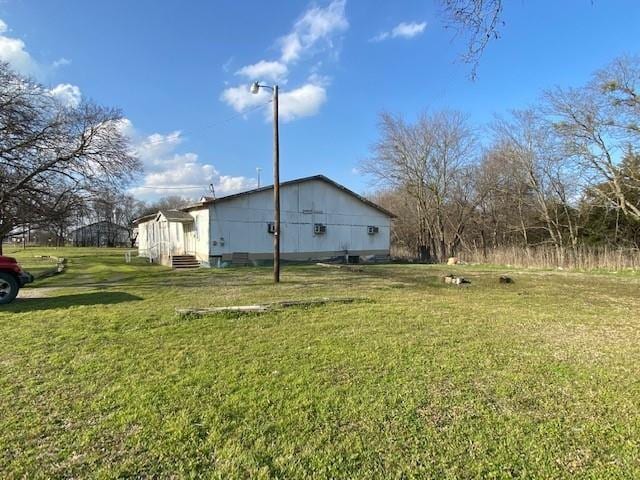 view of side of home featuring a lawn