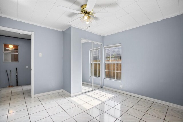 spare room featuring light tile patterned floors and ceiling fan