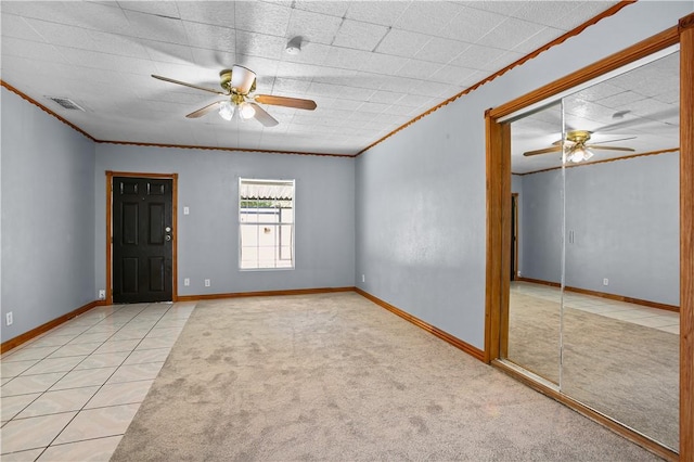 unfurnished room with light carpet, ceiling fan, and crown molding