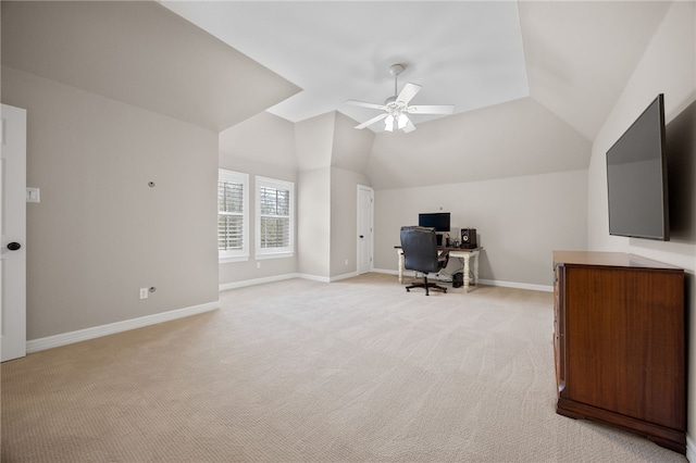 office area with lofted ceiling, ceiling fan, baseboards, and light colored carpet