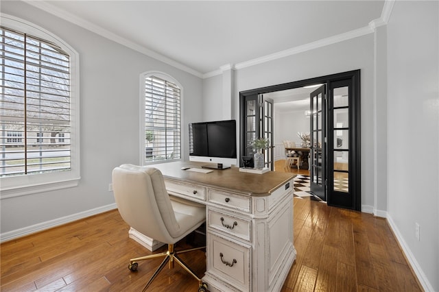 office area with wood-type flooring, crown molding, and baseboards