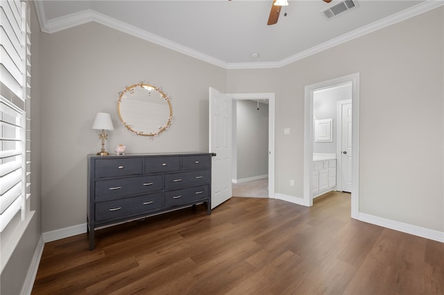 unfurnished bedroom with baseboards, dark wood-style flooring, visible vents, and crown molding