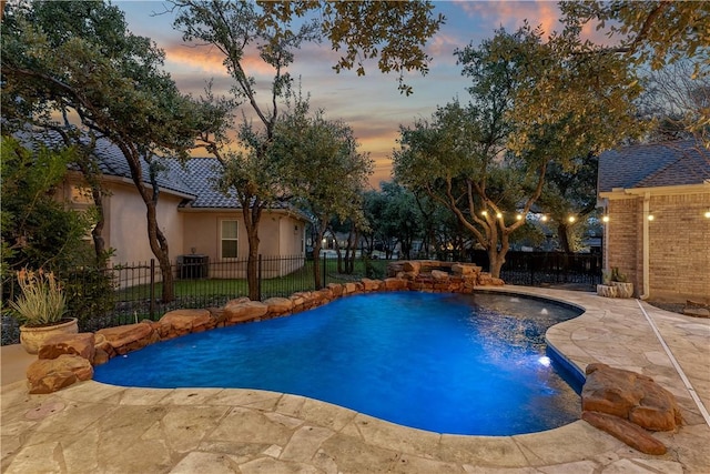 view of swimming pool with a fenced in pool, a patio area, a fenced backyard, and central AC