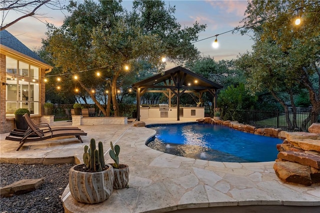 view of pool featuring a patio area, a fenced backyard, a fenced in pool, and area for grilling