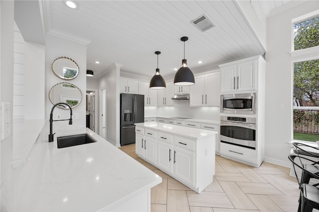 kitchen with visible vents, ornamental molding, a sink, under cabinet range hood, and black appliances