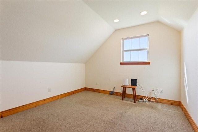 additional living space featuring carpet and vaulted ceiling