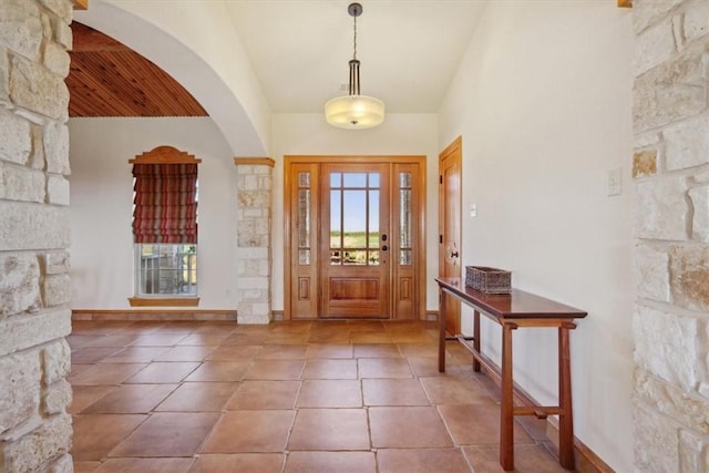 tiled foyer featuring high vaulted ceiling