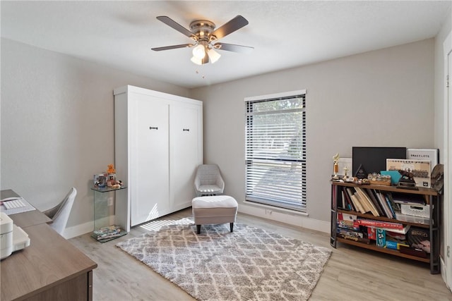 sitting room with light hardwood / wood-style flooring and ceiling fan