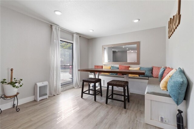 dining area with breakfast area and light hardwood / wood-style floors