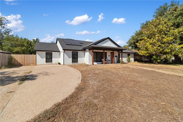 view of front of house with solar panels and covered porch