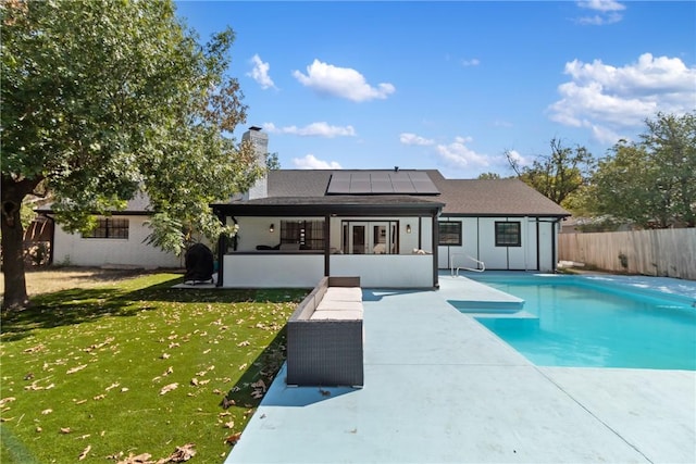 view of pool with a lawn, a sunroom, and a patio