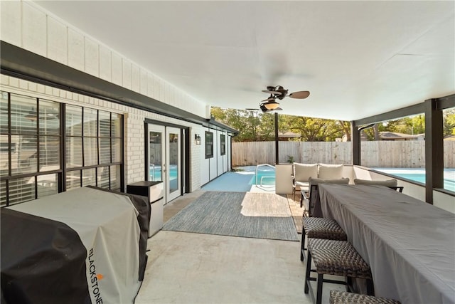 view of patio with a fenced in pool, area for grilling, ceiling fan, and french doors