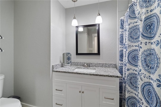 bathroom featuring vanity and toilet