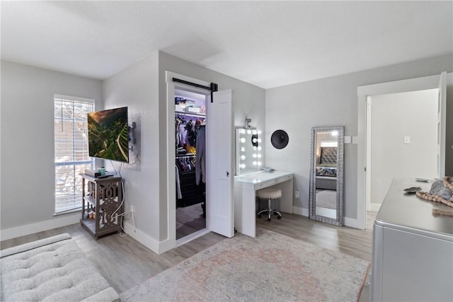 bedroom with light hardwood / wood-style floors and a closet