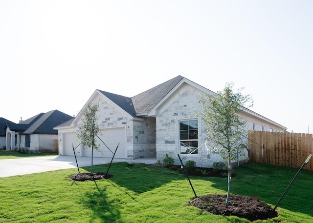 view of front of home with a front yard and a garage