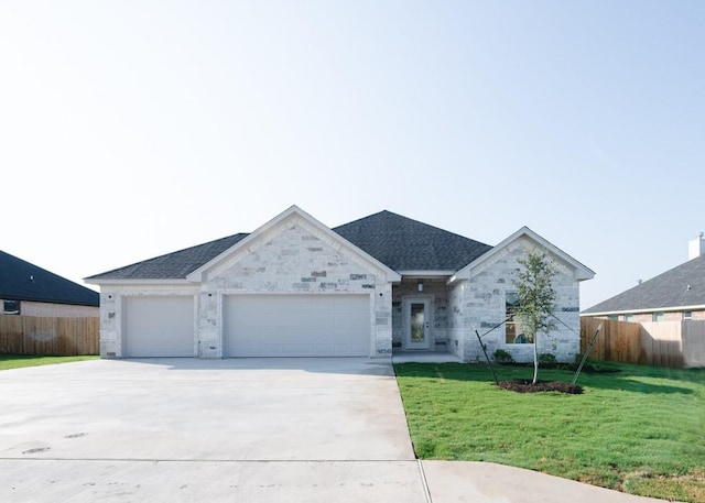 single story home featuring a garage and a front yard