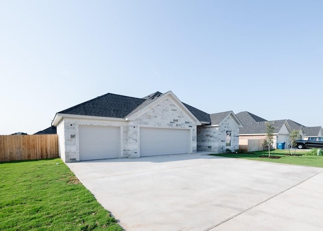 ranch-style home featuring a front yard and a garage