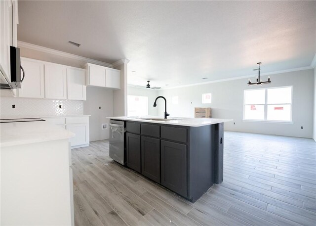 kitchen with sink, stainless steel dishwasher, decorative light fixtures, a kitchen island with sink, and white cabinets