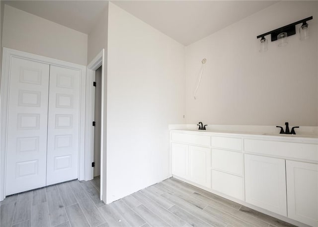 bathroom with hardwood / wood-style floors and vanity