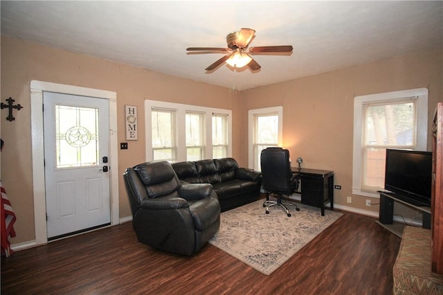 living room with plenty of natural light, ceiling fan, and dark hardwood / wood-style flooring