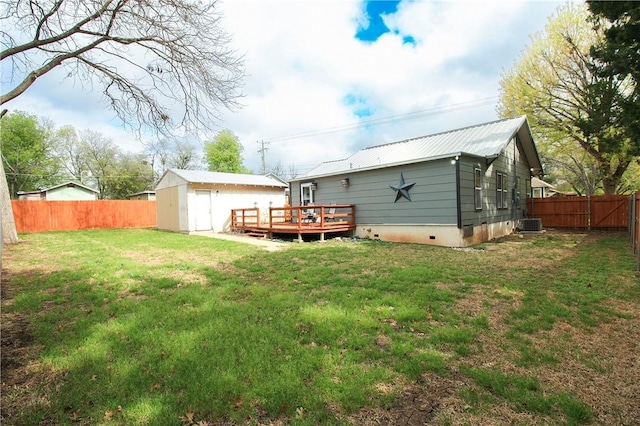 back of property with a lawn, central AC unit, a shed, and a wooden deck