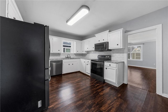 kitchen featuring appliances with stainless steel finishes, dark hardwood / wood-style floors, sink, and white cabinets