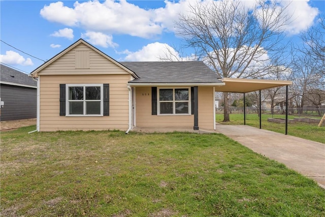 view of front of home with a carport and a front lawn