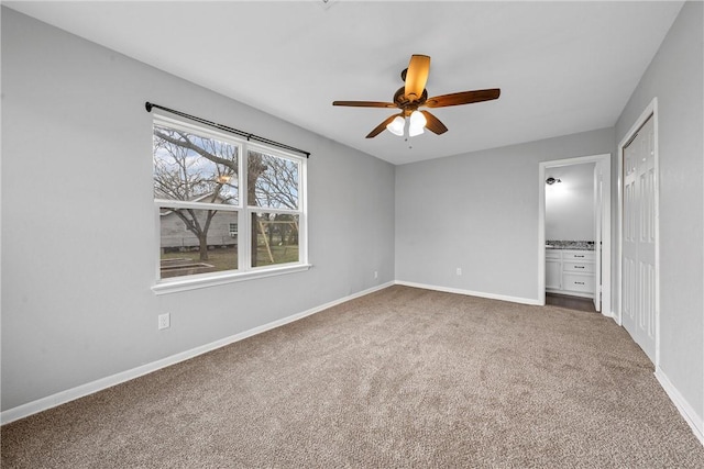 unfurnished bedroom featuring carpet floors, ceiling fan, and ensuite bathroom